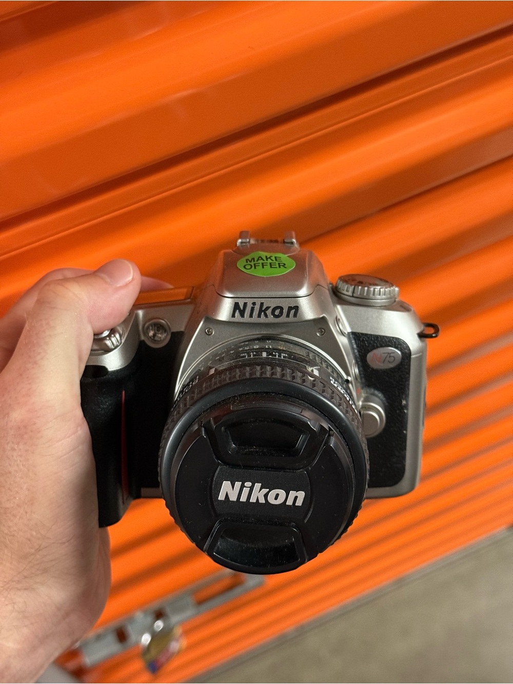 Nikon Silver and Black DSLR Camera with Nikon Lens Cap